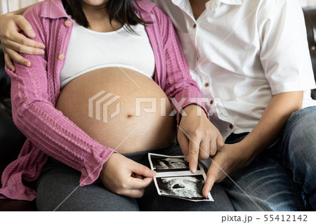 Pregnant couple feels love and relax at home. 55412142