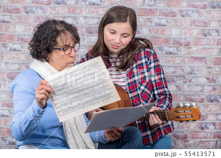 young teenager learning to play the guitar with young teenager learning to play the guitar with 55413571