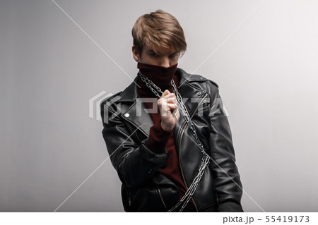Young man with a fashionable hairstyle in red golf 55419173