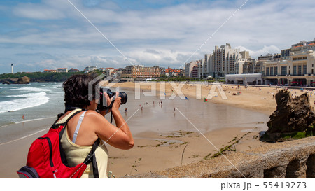 female photographer taking a photograph of the 55419273