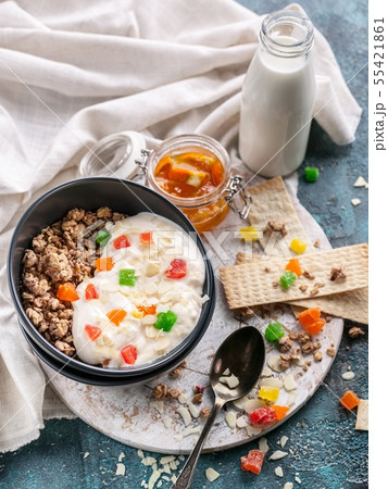 Muesli or Granola with candied fruit in a bowl Muesli or Granola with candied fruit in a bowl 55421861
