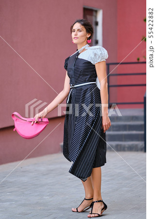 Cute fashionable lady in long striped dress Cute fashionable lady in long striped dress 55422882