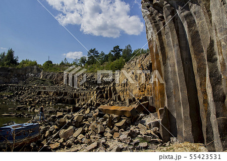 Excavator and basalt columns rocks. Heavy industry 55423531