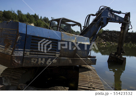Excavator and basalt columns rocks. Heavy industry 55423532