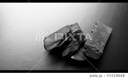 Black color wooden charcoals on dark background 55428688