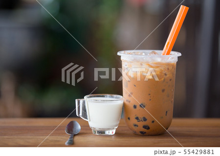 Ice bubble milk tea in takeaway glass. 55429881