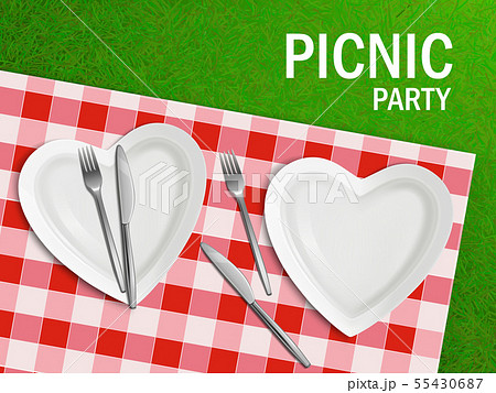 Heart shaped plate on tablecloth and green grass 55430687