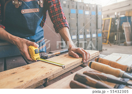 Carpenter working with equipment on wooden table Carpenter working with equipment on wooden table 55432305