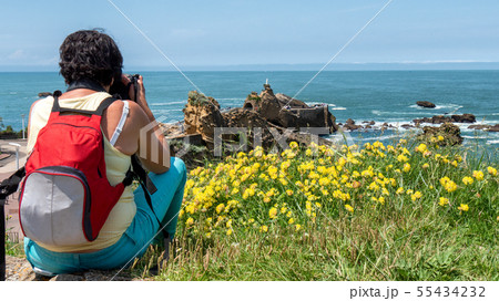 woman take picture from Rock of the Virgin, 55434232