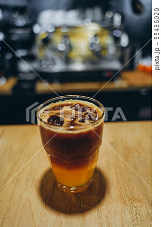 Glass with cold coffee and ice and orange. Glass with cold coffee and ice and orange. 55436020