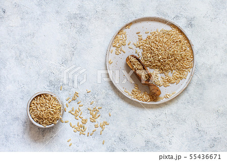 Brown rice in a wooden bowl with a spoon Brown rice in a wooden bowl with a spoon 55436671