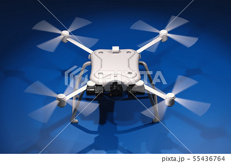 white drone with spinning propellers 55436764