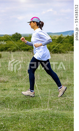 Spanish woman running on meadow 55438552