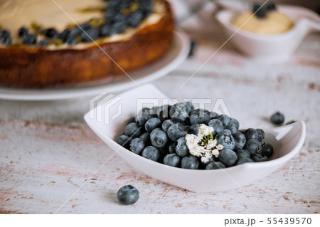 Fresh blueberry, cheesecake dessert on white table Fresh blueberry, cheesecake dessert on white table 55439570