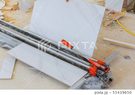 Cutting worker working with floor tile cutting 55439650