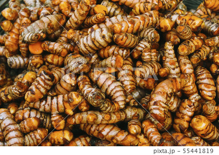 Fresh turmeric for sale in market, close-up. 55441819