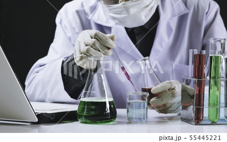 Researcher with glass laboratory chemical test 55445221