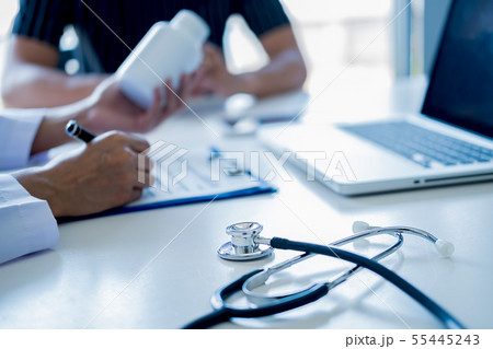 Patient listening intently to a male doctor Patient listening intently to a male doctor 55445243