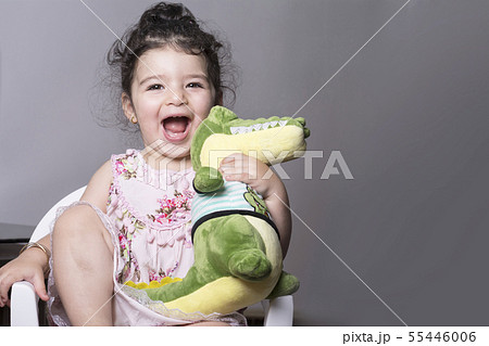 Surprised and happy little girl holding an 55446006