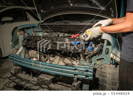 Worker repairing car body. 55446034