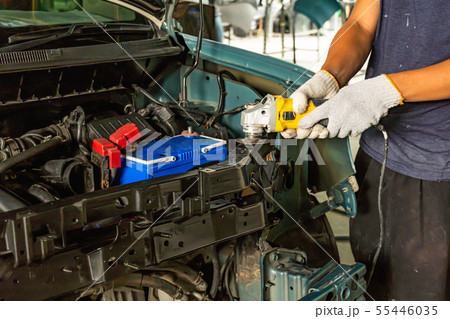 Worker repairing car body. 55446035