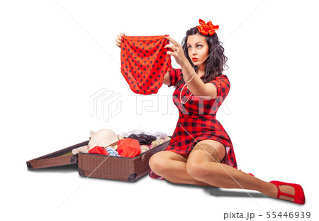 young woman sitting on the floor and putting 55446939