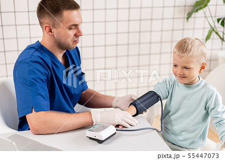 Doctor measuring blood pressure of a little boy. Diagnostic, healthcare, medical service. Doctor 55447073
