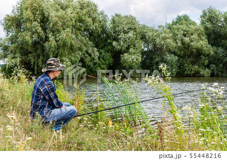 Fisherman fishes on the lake 55448216