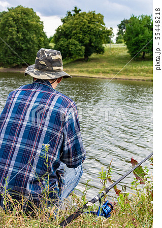 Fisherman fishes on the lake 55448218