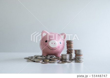 pink piggy bank saving money with coins pile pink piggy bank saving money with coins pile 55448747