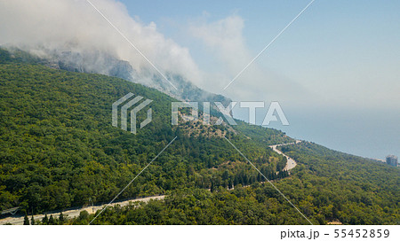 Crimean roads: aerial view of curvy mountain road in summer day Crimean roads: aerial view of curvy mountain road in summer day 55452859
