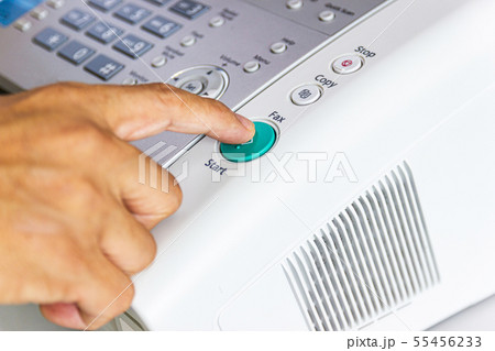 hand man are using a fax machine in the office 55456233