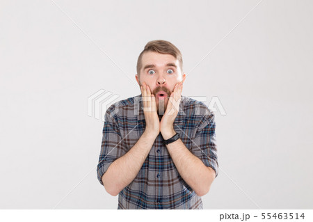 Stylish young hipster man with a mustache and beard joyfully opens his mouth on a white background 55463514