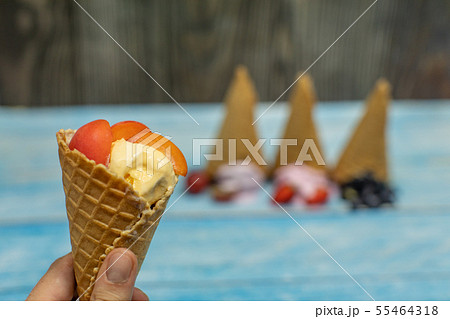 Sweet ice cream in balls in a waffle cone. Different flavors berries and fruits 55464318