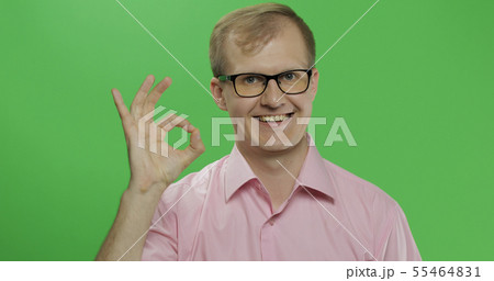 Caucasian man in pink shirt showing OK gesture. Chroma key Caucasian man in pink shirt showing OK gesture. Chroma key 55464831