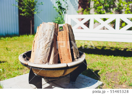 Close-up, roaring fire with blurred flames from wood logs in a stone firepit. 55465328
