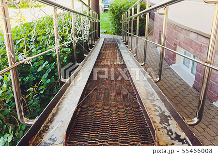 Ramp for wheelchair entry with metal handrails. 55466008