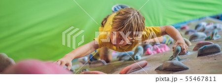 little boy climbing a rock wall in special boots. indoor BANNER, LONG FORMAT little boy climbing a rock wall in special boots. indoor BANNER, LONG FORMAT 55467811