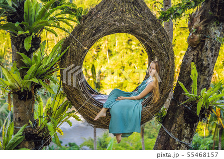 Bali trend, straw nests everywhere. Young tourist enjoying her travel around Bali island, Indonesia Bali trend, straw nests everywhere. Young tourist enjoying her travel around Bali island, Indonesia 55468157