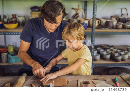 Father and son doing ceramic pot in pottery workshop 55468726
