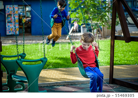 Smiling little boy and his brother friend on a Smiling little boy and his brother friend on a 55469305
