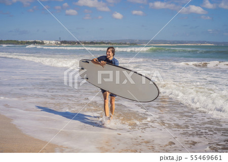 Surfer with his surfboard running to the waves Surfer with his surfboard running to the waves 55469661
