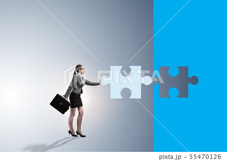 Concept of businesswoman with missing jigsaw puzzle piece Concept of businesswoman with missing jigsaw puzzle piece 55470126
