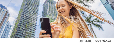 Woman Tourist using navigation app on the mobile phone. Navigation map on a smartphone in a big city Woman Tourist using navigation app on the mobile phone. Navigation map on a smartphone in a big city 55470238