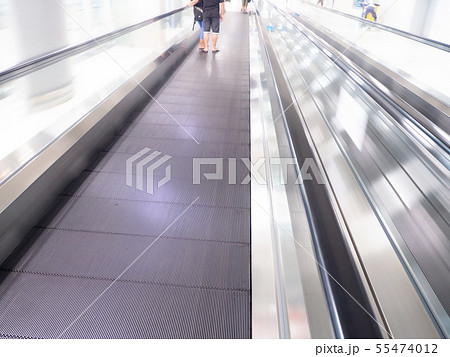 skywalk with blurred business people in airport skywalk with blurred business people in airport 55474012