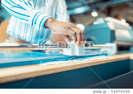 Man wearing striped shirt using technique in publishing office 55474330