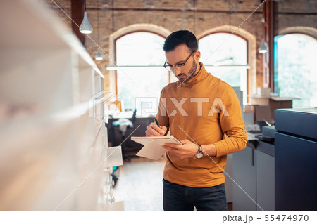 Graphic designer working on book design making some notes Graphic designer working on book design making some notes 55474970