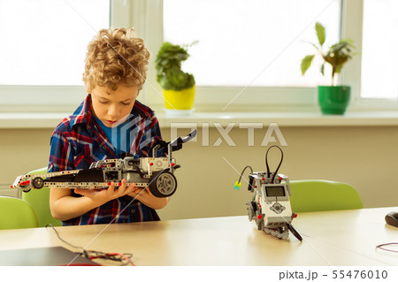 Nice concentrated boy thinking about his project Nice concentrated boy thinking about his project 55476010