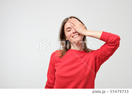 Pleased Caucasian woman wearing red sweater Pleased Caucasian woman wearing red sweater 55479733
