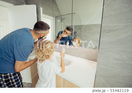 Positive nice father and son shaving together Positive nice father and son shaving together 55482119